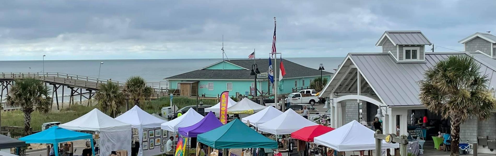 aerial view of craft vendor booths set up in a park